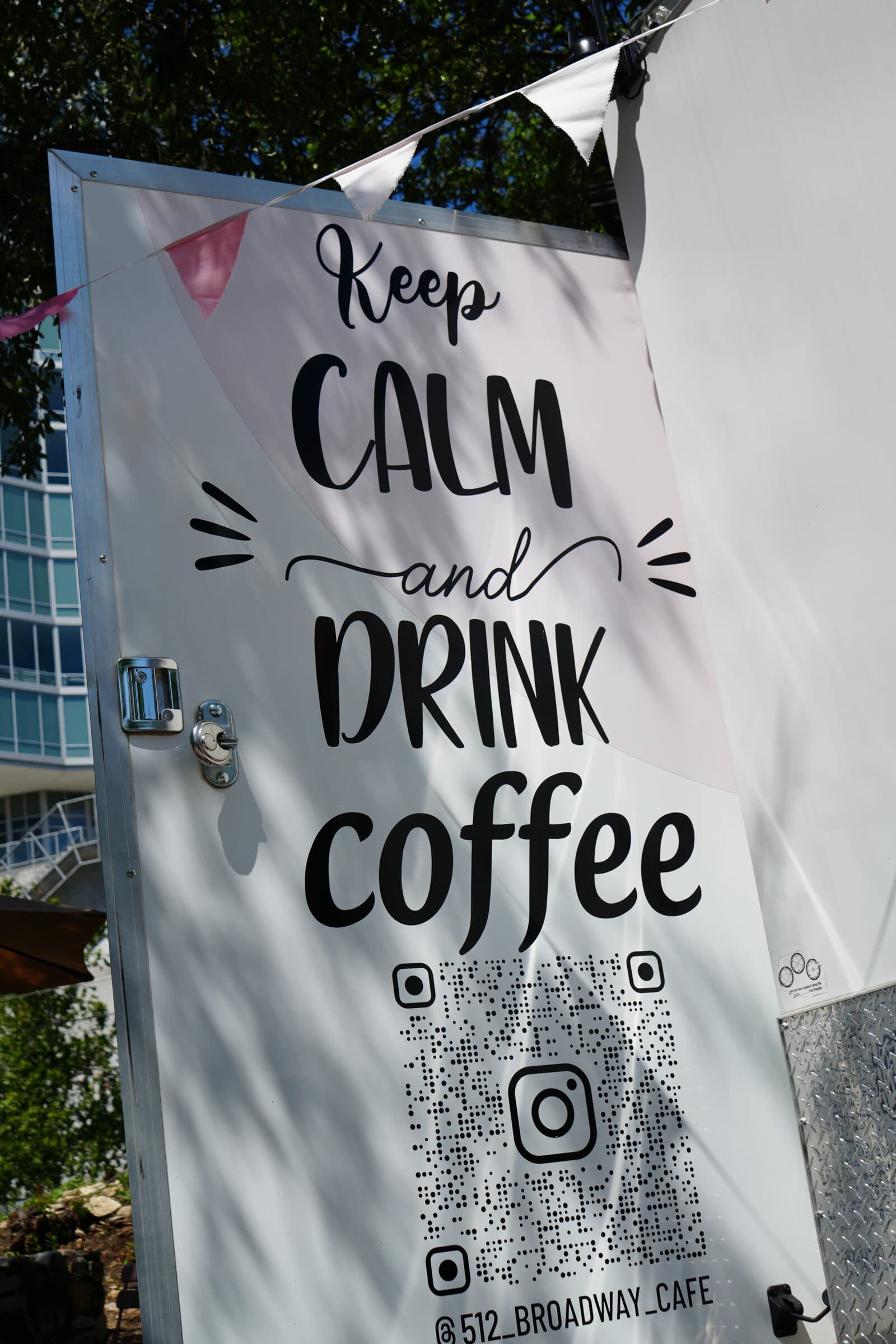 Keep Calm and Drink Coffee sign with a QR code, hung on the truck awning