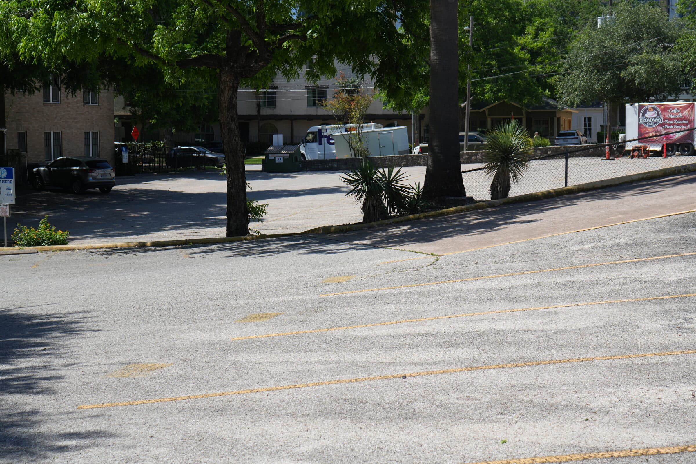 Wide overview of the ANW lot with a food truck and the surrounding tree canopy
